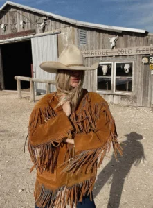 Tan 1970s fringe leather jacket with horn button closure and Western-style detailing