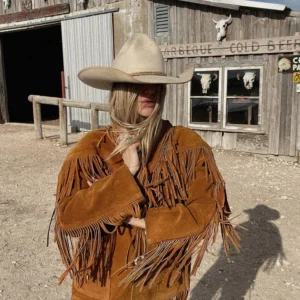 Tan 1970s fringe leather jacket with horn button closure and Western-style detailing