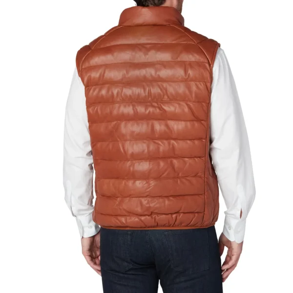 Man wearing a cognac leather puffer vest with front zipper, stand collar, and two pockets